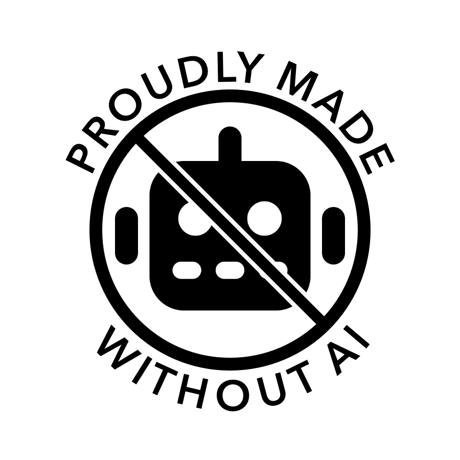 Circle with a slash across an emoji robot face. The words 'proudly made without AI' are around the outside edge of the circle
